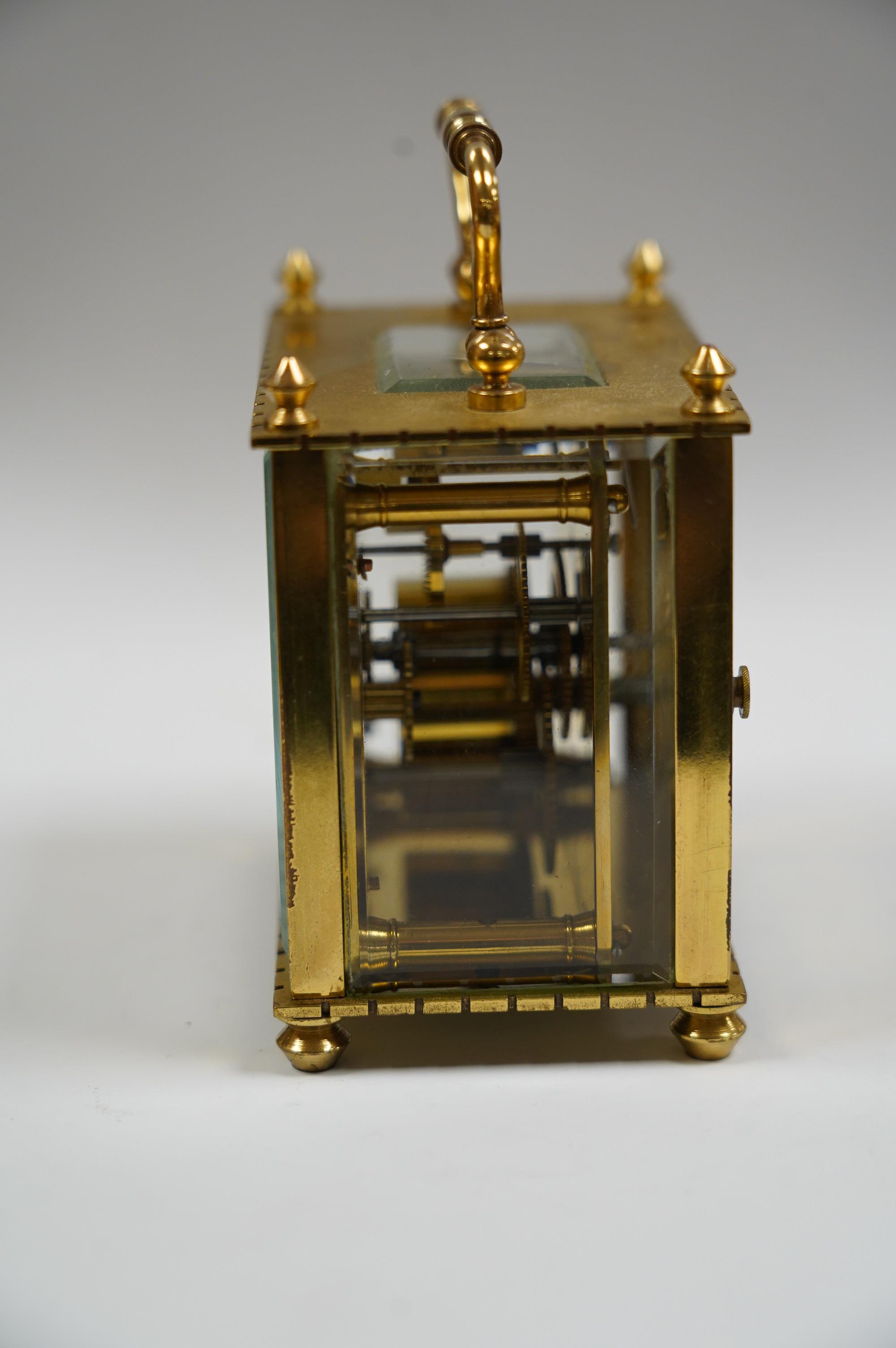 A small French brass cased eight day carriage timepiece, 9cm tall. Condition - fair to good, not tested